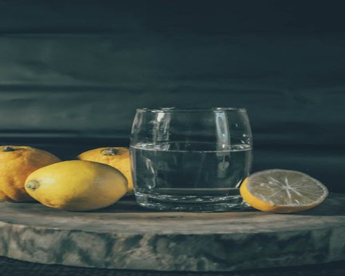 A glass of fresh water with lemon slices